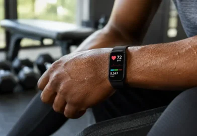 A person wearing a fitness tracker with heart rate monitor on their wrist after a workout, showing a live heart rate reading on the screen.